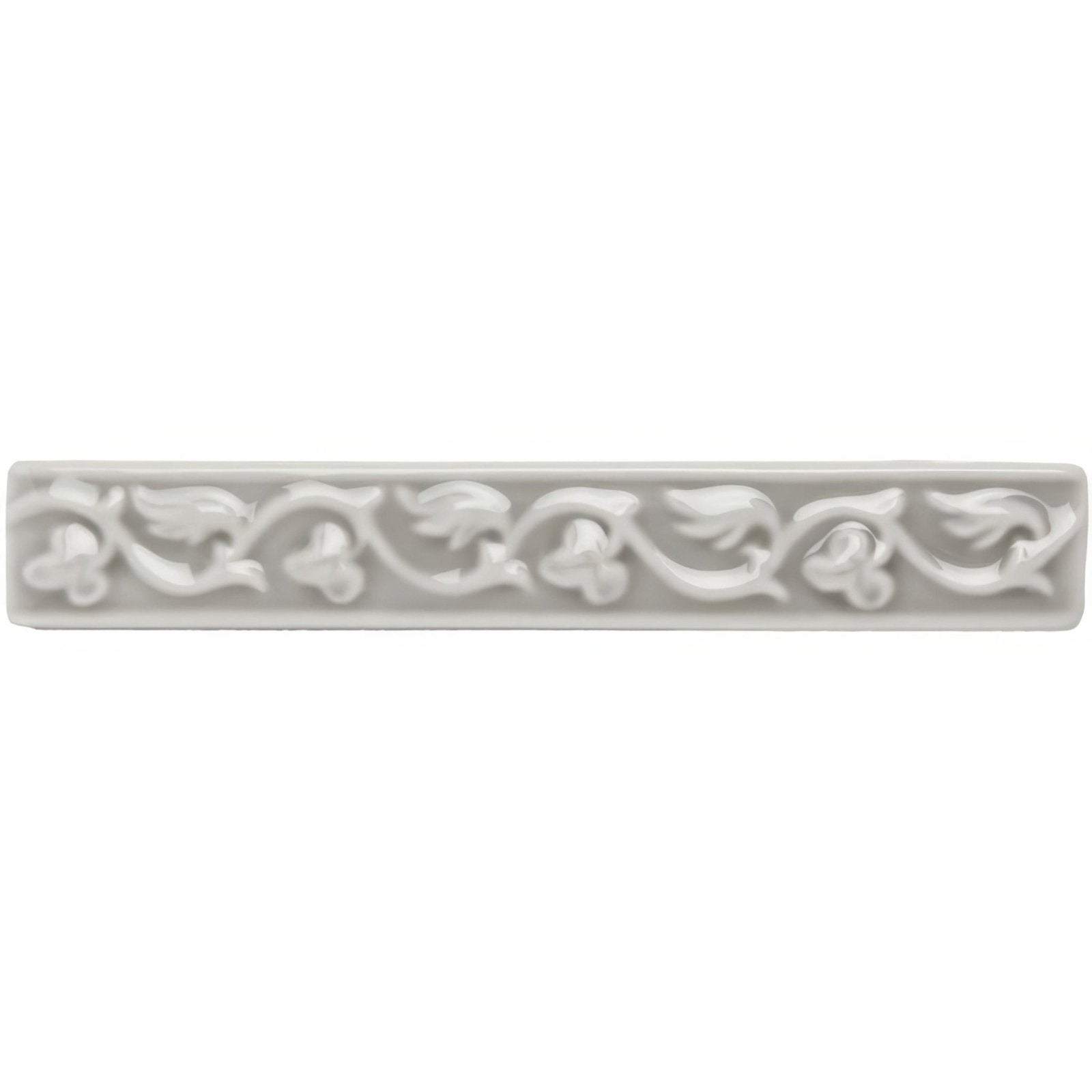 Dunwich Beaulieu white ceramic tile with ornate raised floral and vine pattern along its length
