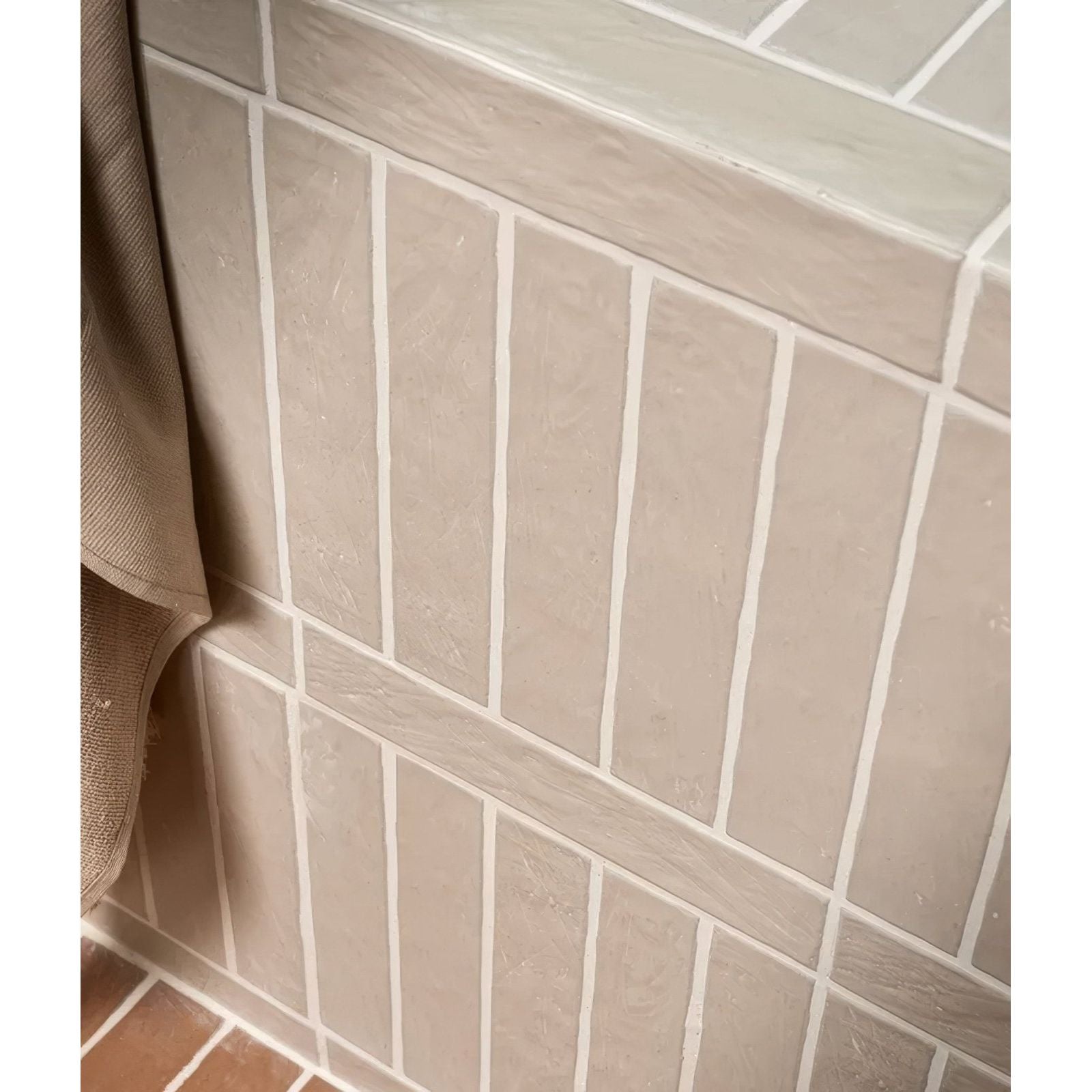 Beige rectangular earthenware porcelain plaster tiles with subtle texture and white grout lines