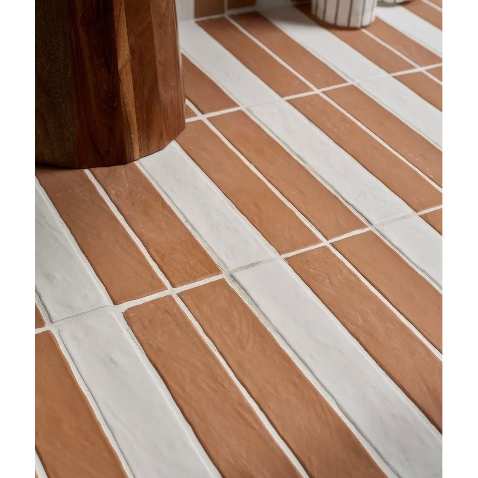Earthenware porcelain red clay floor tiles in terracotta and white arranged in a staggered rectangular pattern