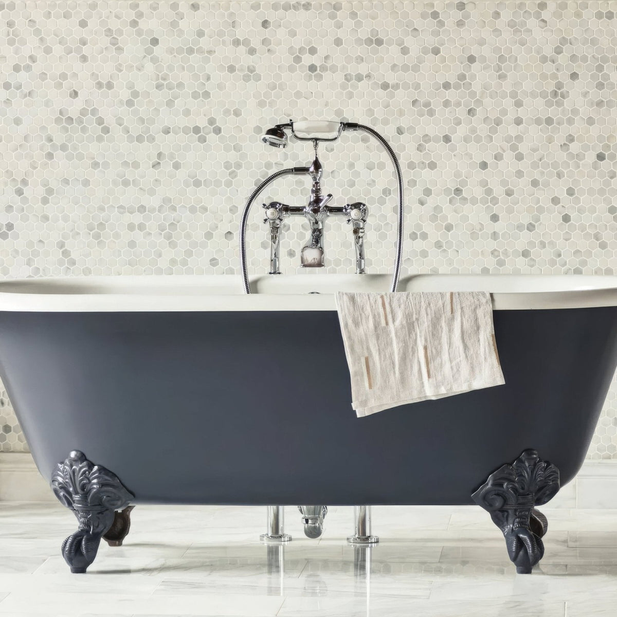 East Hampton Hexagon Marble Mosaic white marble hexagon mosaic with a dark grey clawfoot bathtub