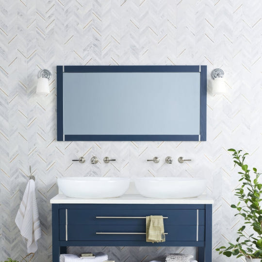 East Hampton Marble Chevron Mosaic white marble and gold chevron mosaic with a navy mirror and wall sconces