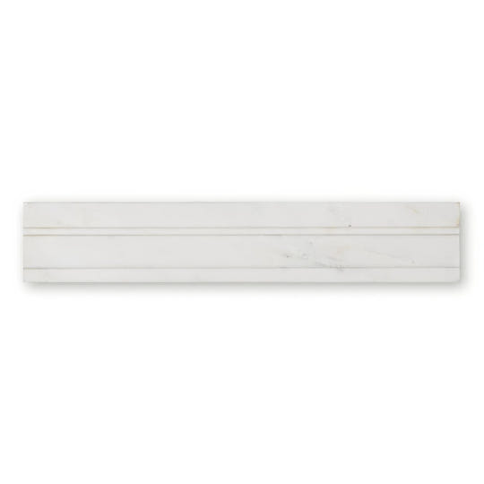 White marble subway tile with subtle veining and sleek modern design from East Hampton Marble Deco Dado collection