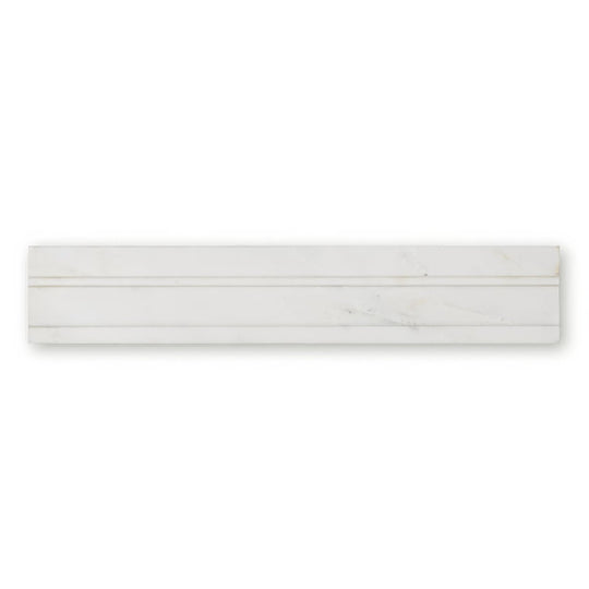 White marble subway tile with subtle veining and sleek modern design from East Hampton Marble Deco Dado collection