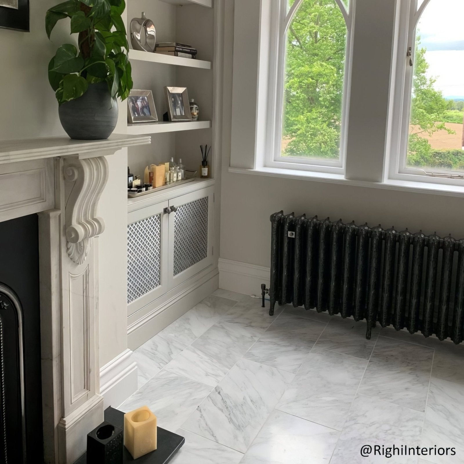 Black cast iron radiator with vertical fins and matte finish complementing east hampton marble tile 30x30cm