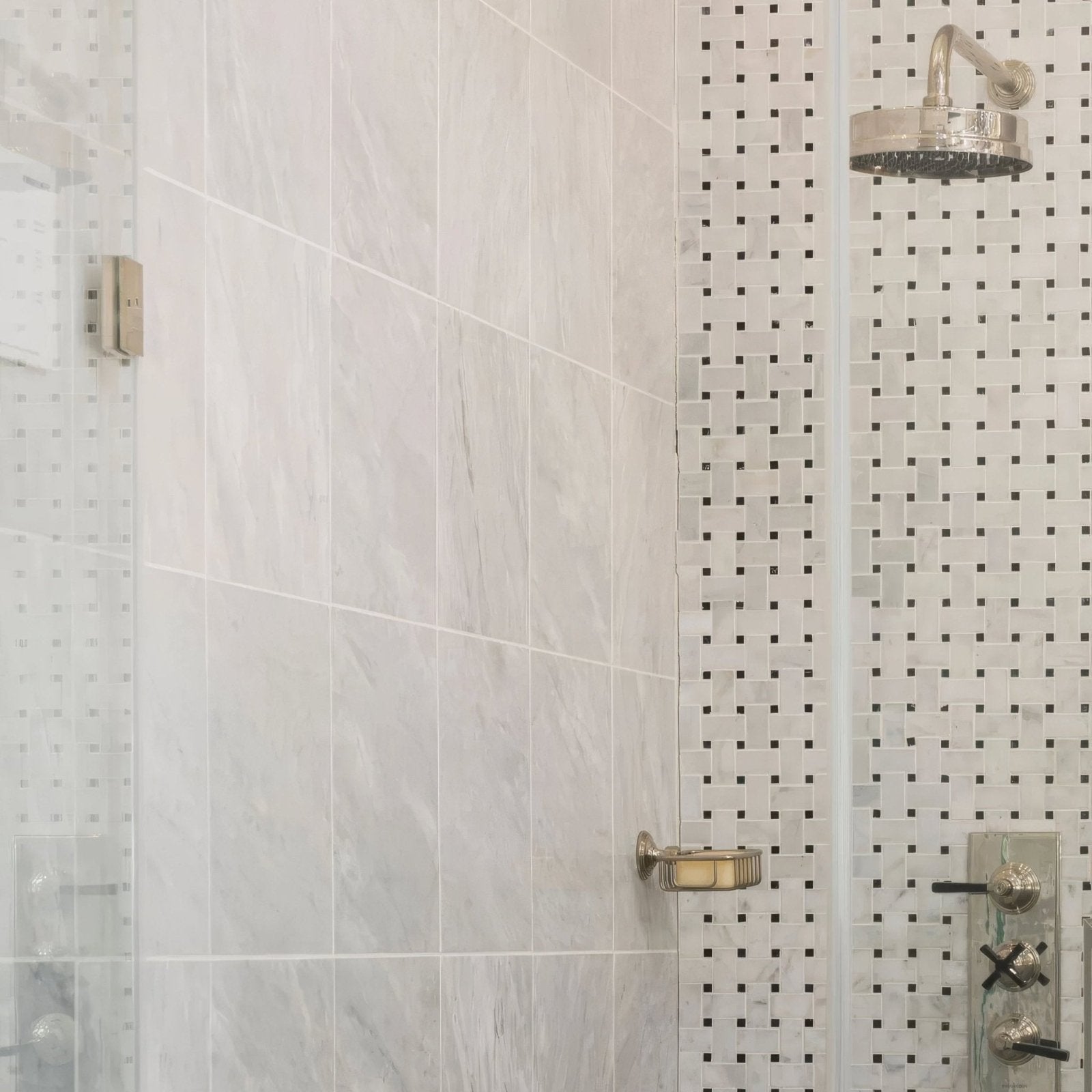 Silver-toned showerhead with circular textured face and polished chrome finish shown on east hampton marble tile 30x30cm