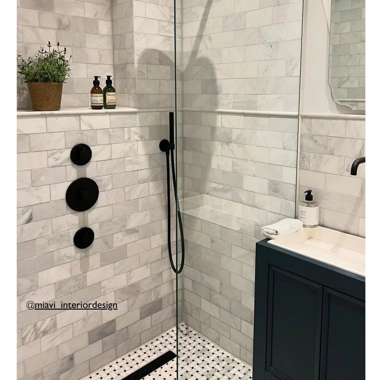 East Hampton Marble Tile 7.5x15cm white marble tiles with a black showerhead