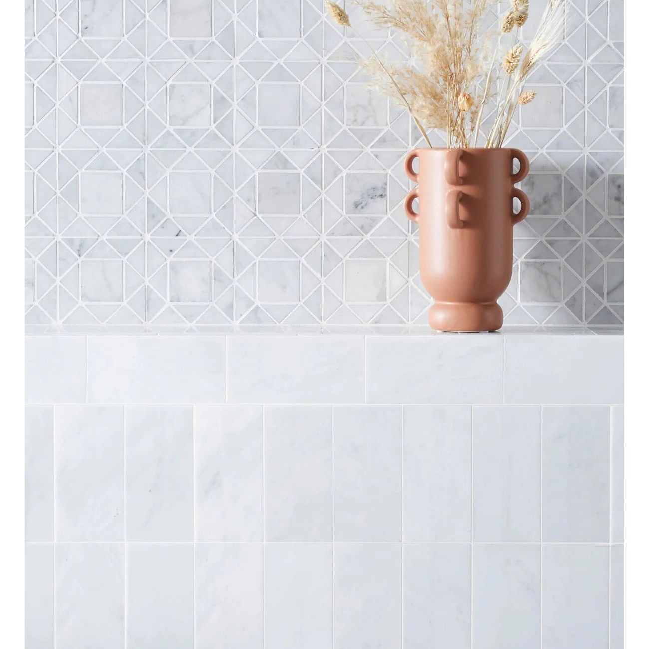 East Hampton Marble Tile 7.5x15cm white marble tiles with a terracotta vase of pampas grass