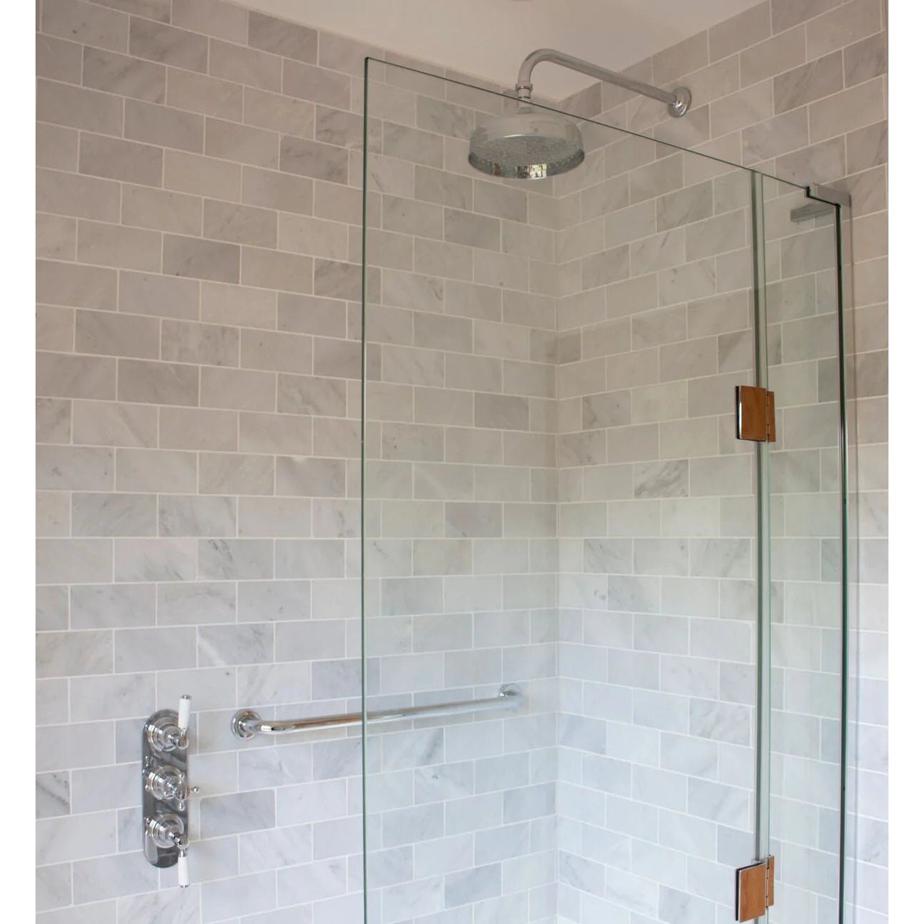 East Hampton Marble Tile 7.5x15cm white marble tiles with a chrome showerhead