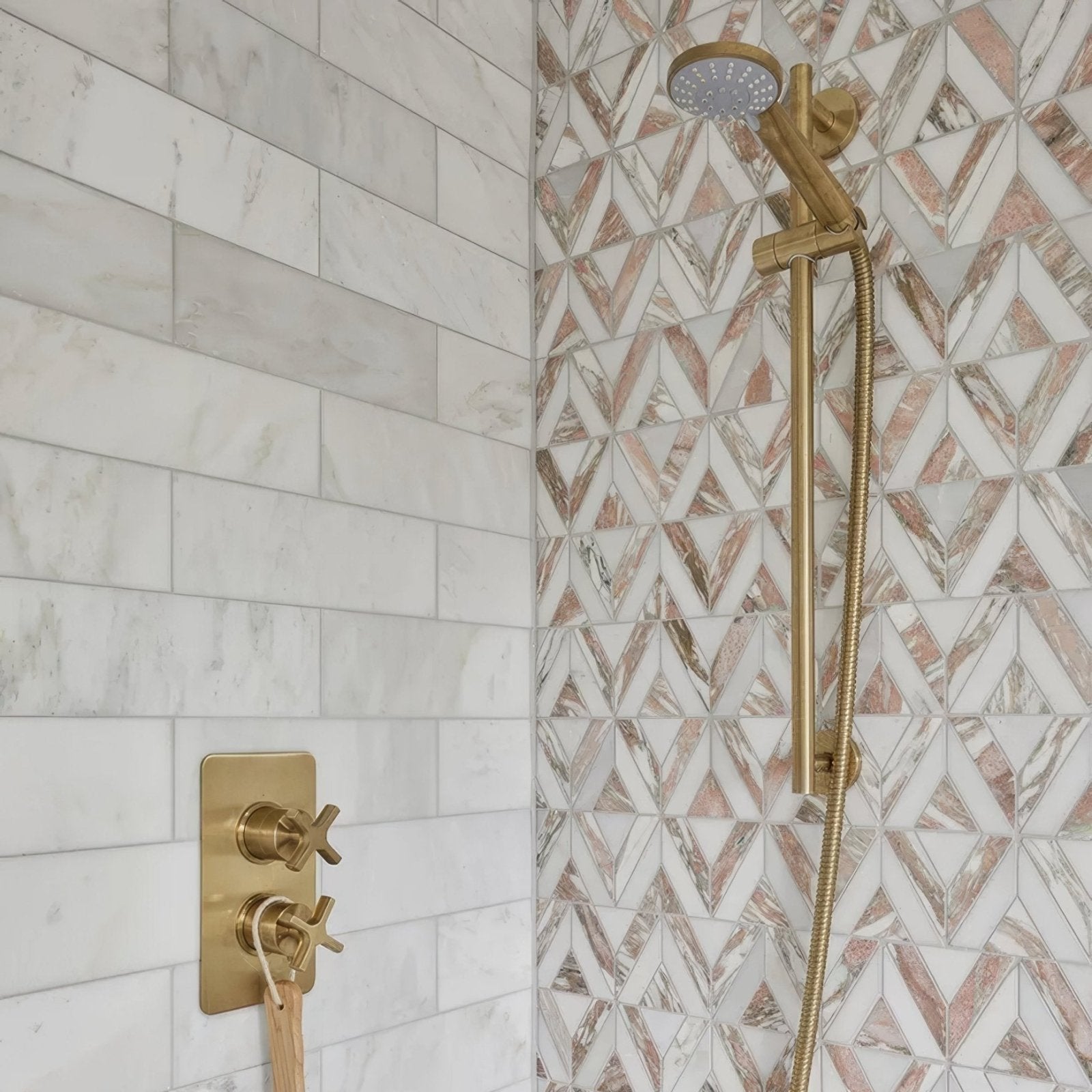 East Java Flamingo Marble Temple Mosaic pink and white marble triangle mosaic with a gold shower fixture