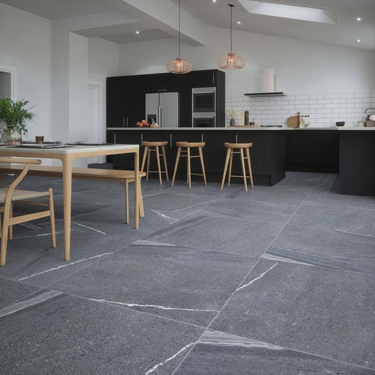 Dark gray eastford anthracite matt porcelain stone tiles with white veining laid in a modern kitchen setting