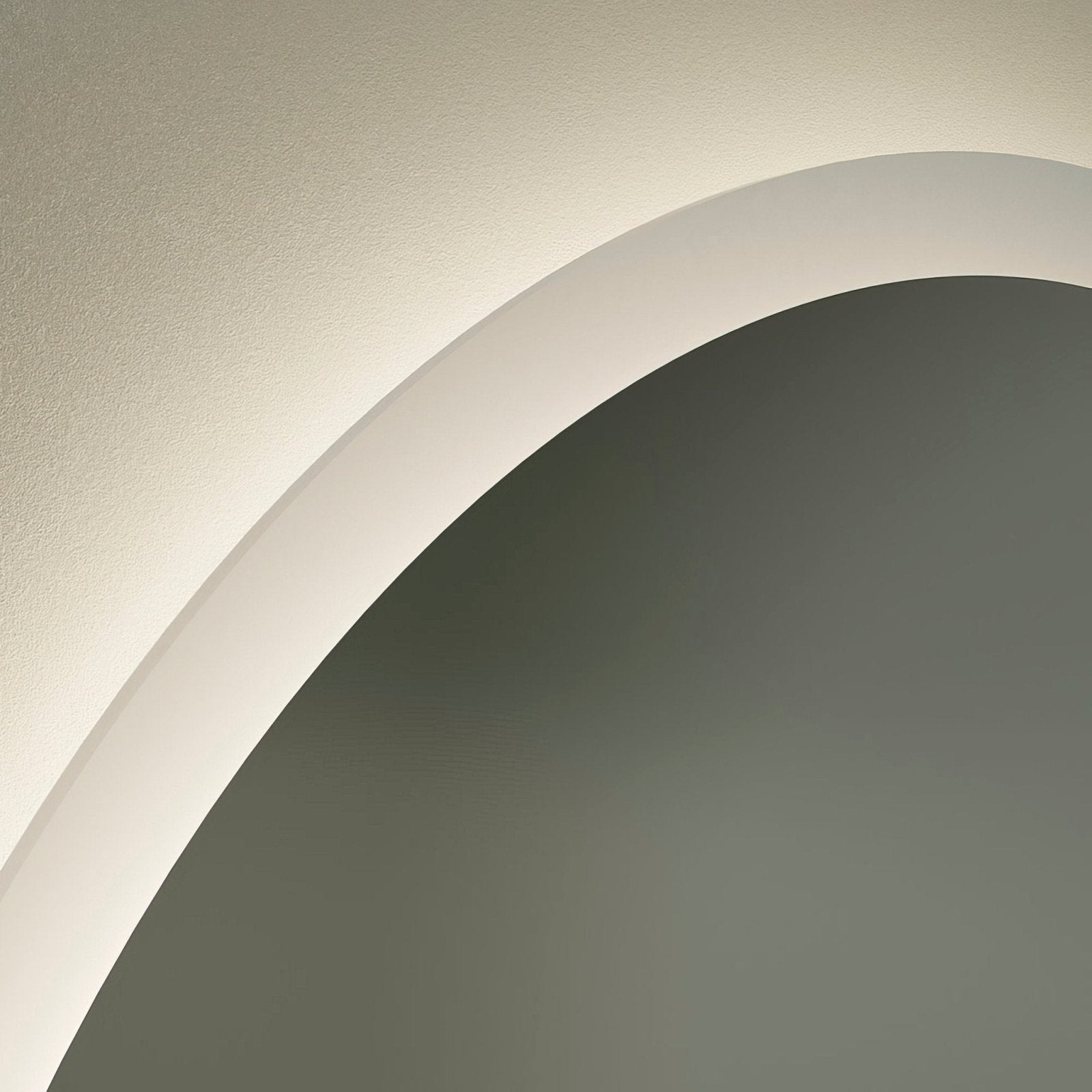 A sleek curved white molding transitioning between two toned walls featured near the edison round mirror 60cm