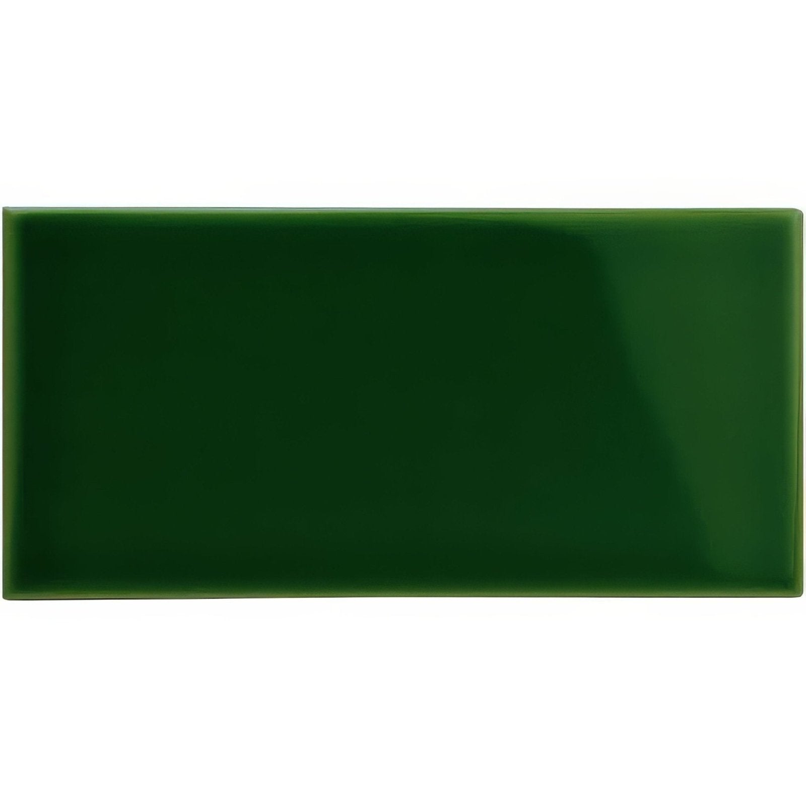 A glossy forest green rectangular ceramic half tile with smooth surface and rounded edges called edwardian green half tile