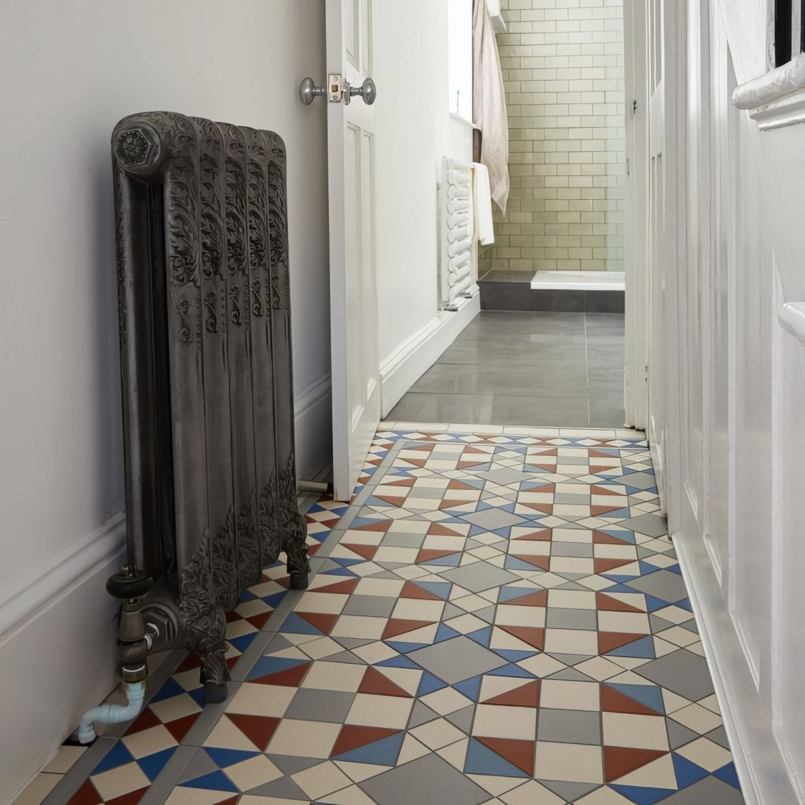 Antique-style dark gray cast iron radiator with ornate carved detailing from eltham blue and red collection