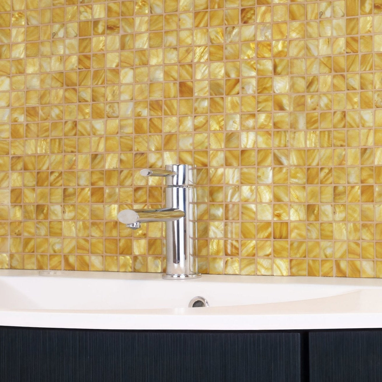 Emerald Gold 25mm Square gold mosaic behind a chrome bathroom tap