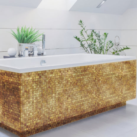 Emerald Gold 25mm Square gold mosaic on a bathtub with a white rim and chrome fixtures