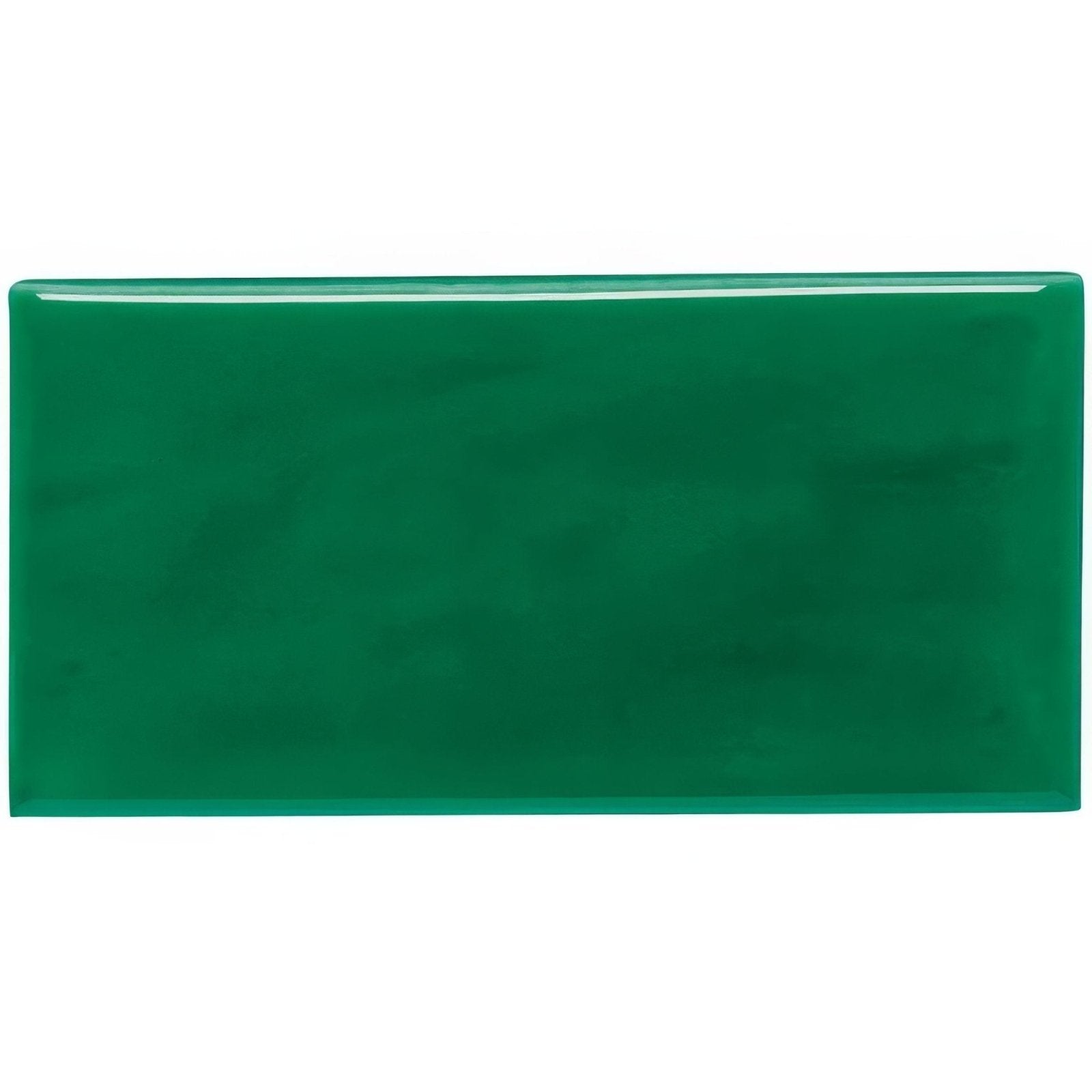 A glossy emerald green rectangular ceramic tile with a smooth reflective surface called emerald green half tile