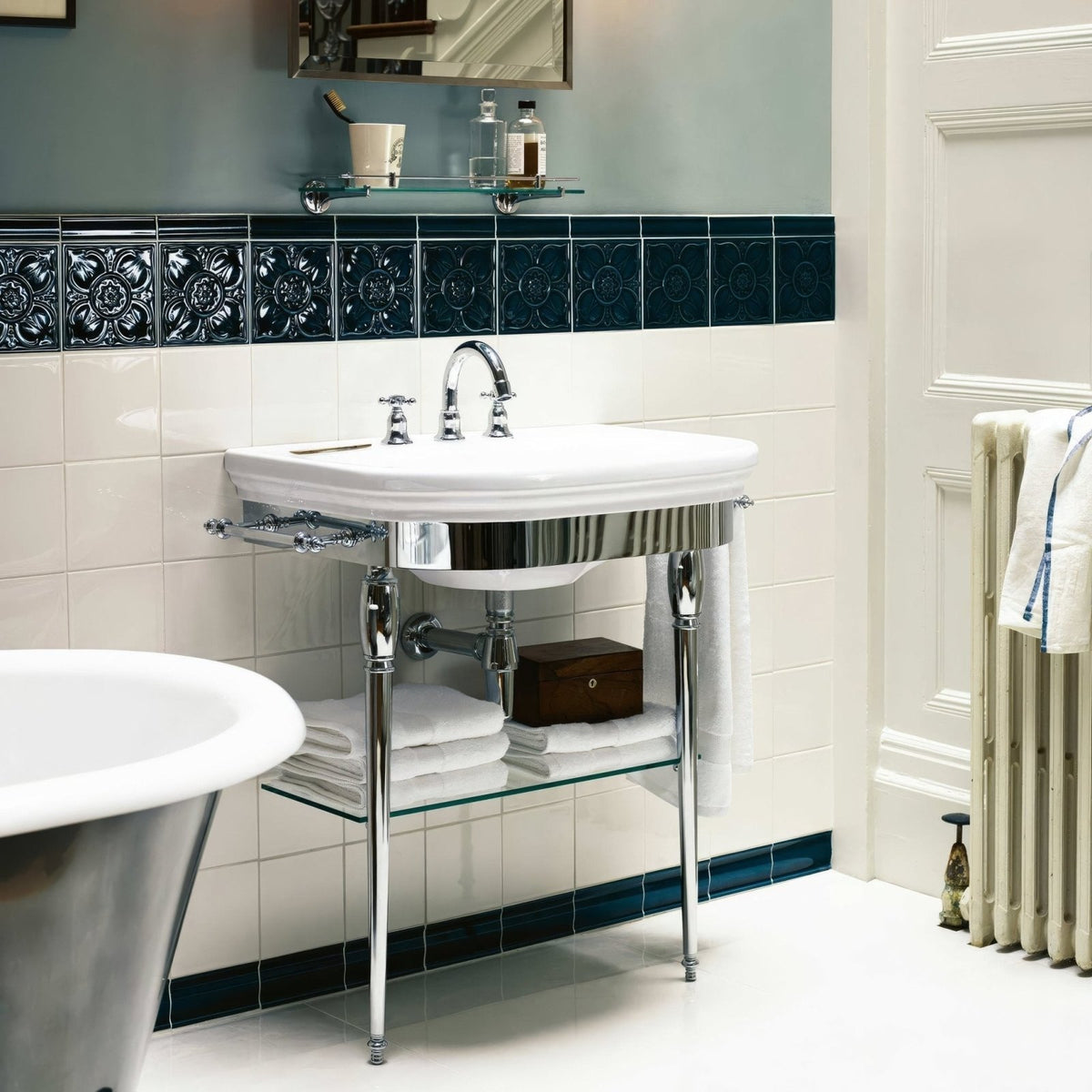 White ceramic Empress Pearl Base pedestal sink with polished chrome legs and matching faucet for bathroom use
