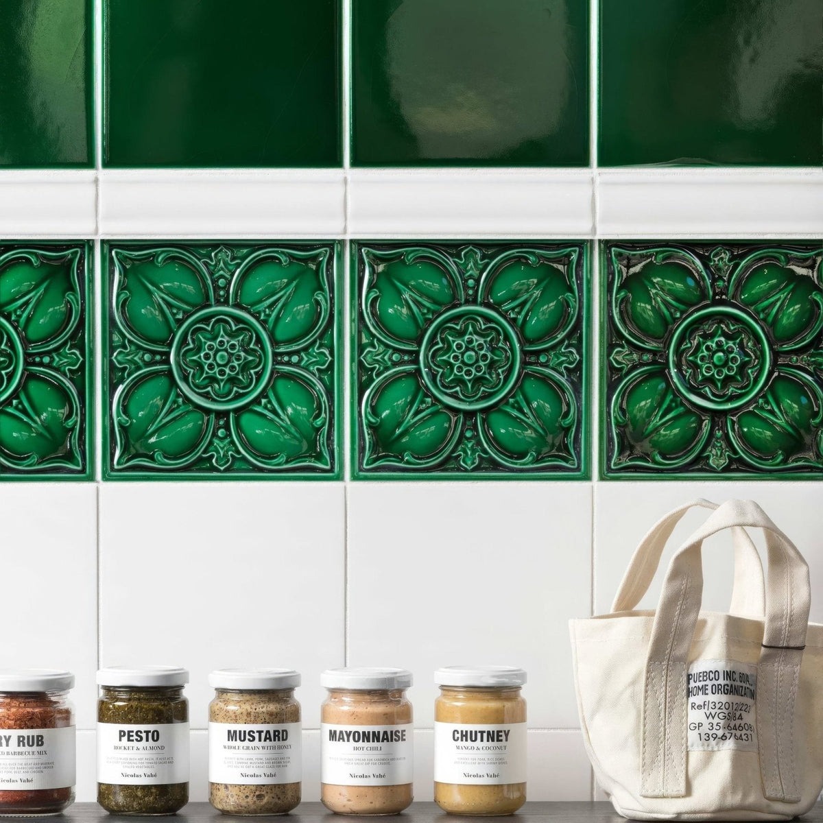 Deep emerald green ceramic tiles with raised floral patterns for wall decoration in empress pearl base collection