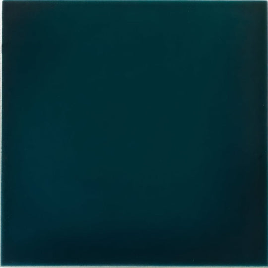 A smooth square ceramic tile with a deep teal glaze in the empress tourmaline base collection
