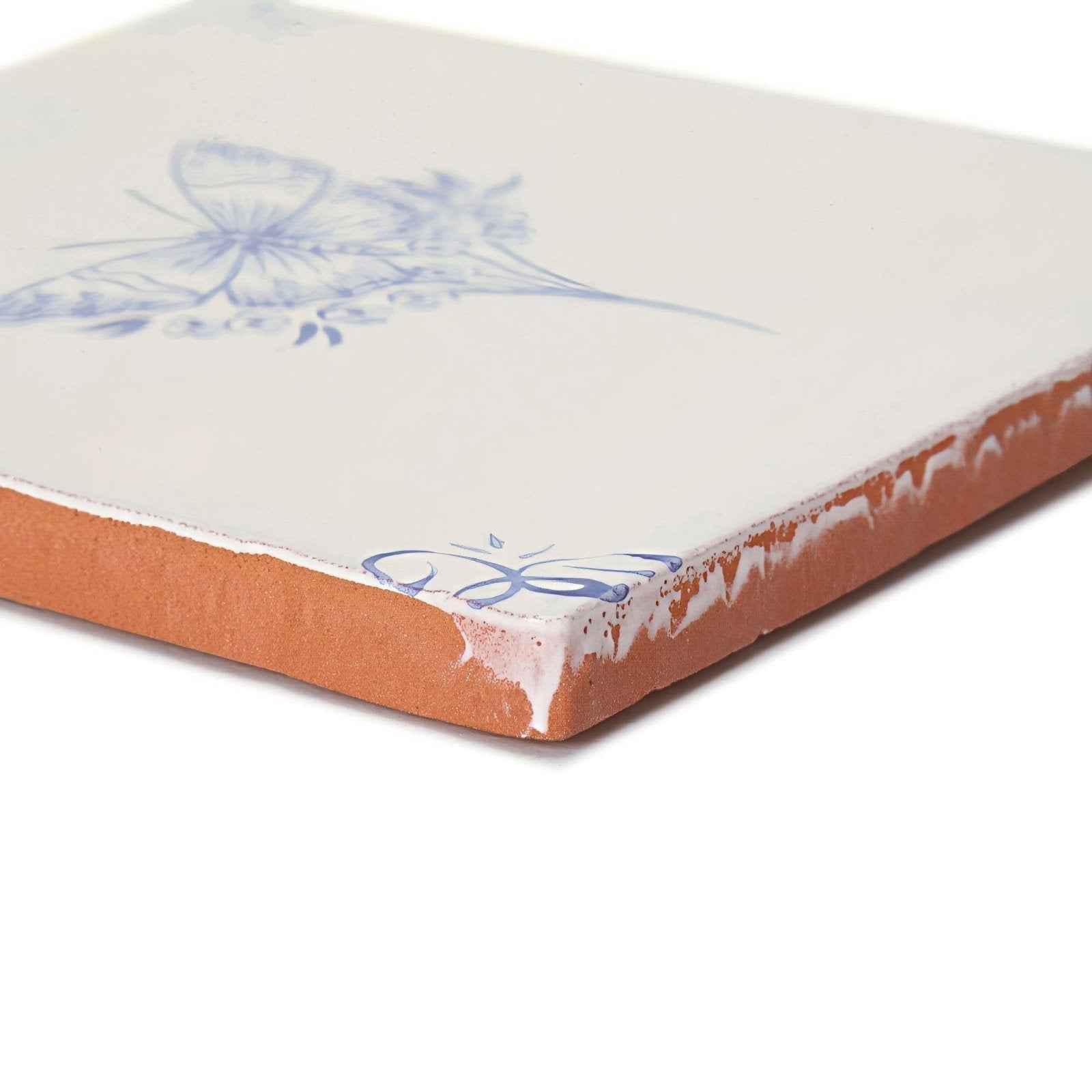 A square english delft butterfly 1 blue gloss ceramic tile with white glaze blue floral design and exposed terracotta edge