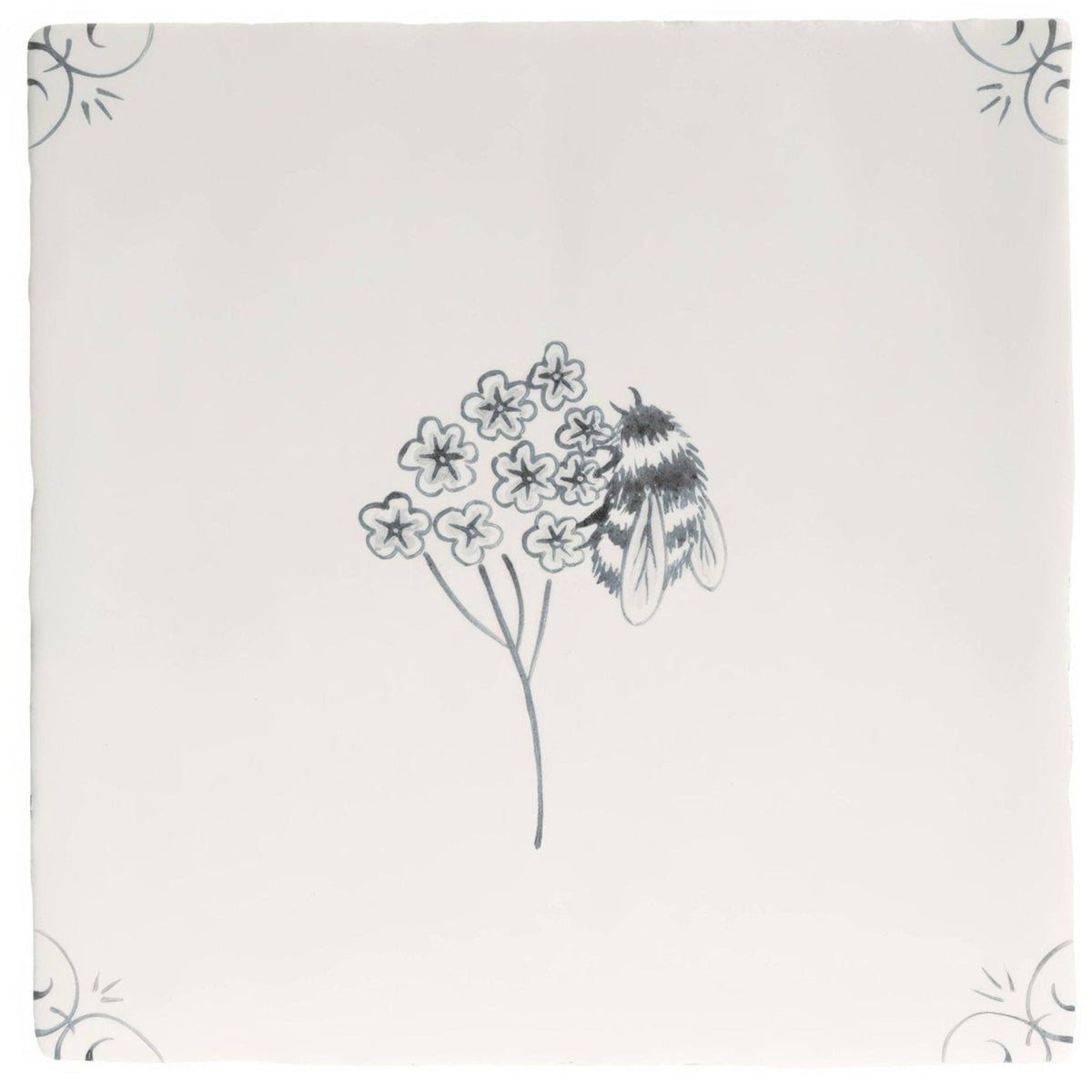 A cream-colored ceramic English Delft charcoal bee tile with a hand-drawn black ink bumblebee and floral design