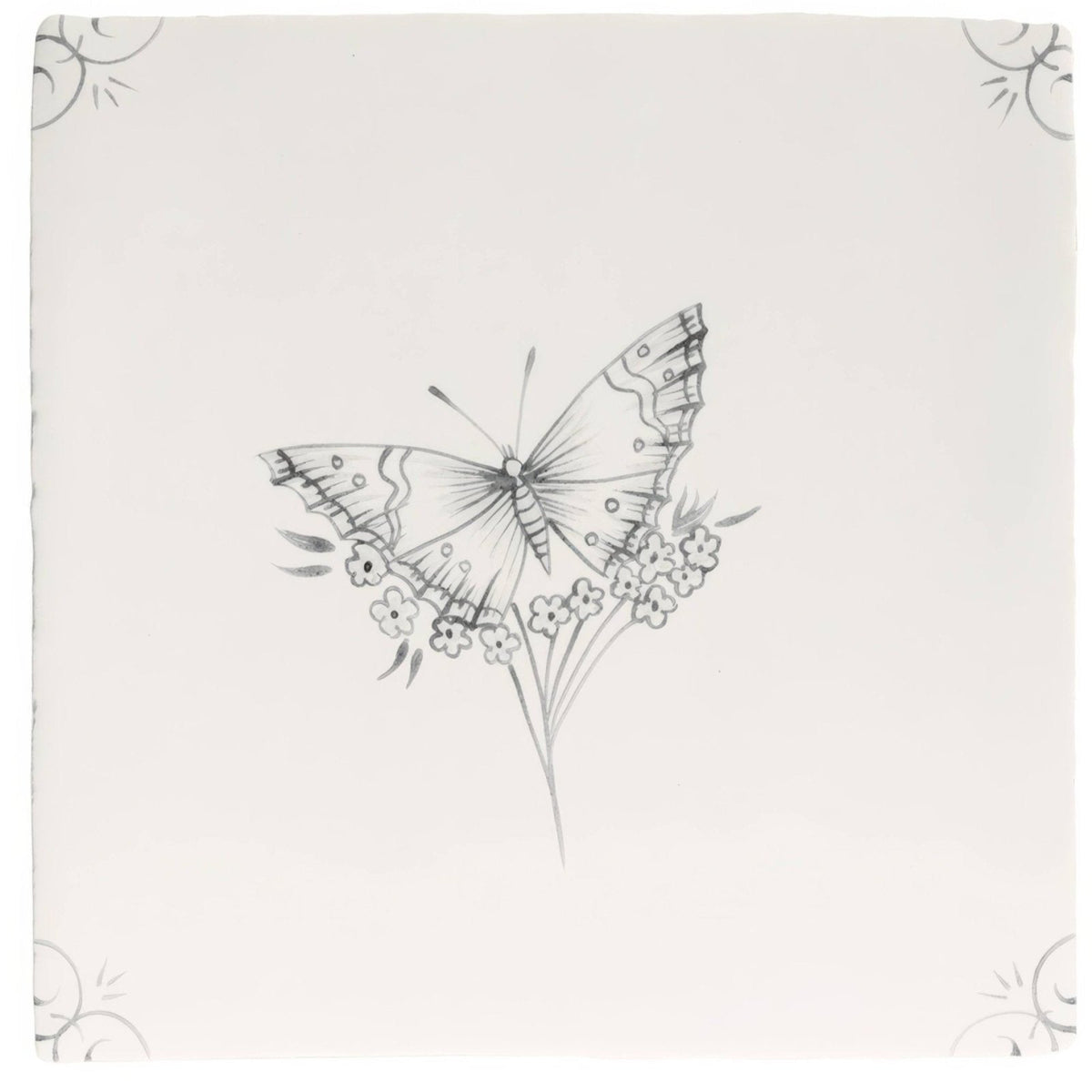 A delicate black and white butterfly illustration on an off white ceramic tile with small flowers in English Delft Charcoal Butterfly 1