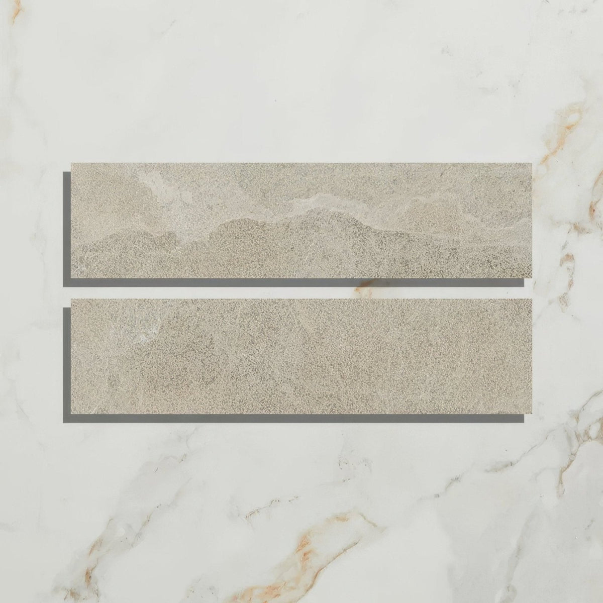 Two rectangular beige enki limestone parquet tiles with textured natural stone effect and velvet finish surface