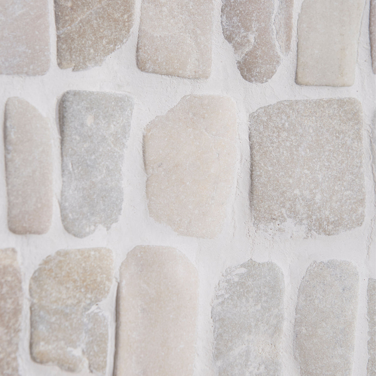 Enso cobble mosaic strip chalk featuring beige and gray rustic irregular stone veneer for wall decoration