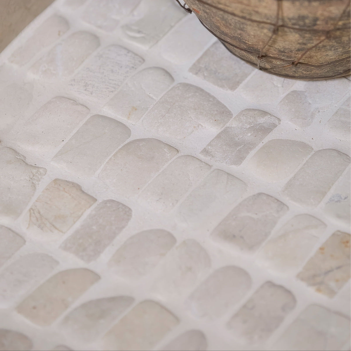 Enso Cobble Mosaic Strip Chalk white stone mosaic with subtle veining and rounded rectangular pieces in an offset grid