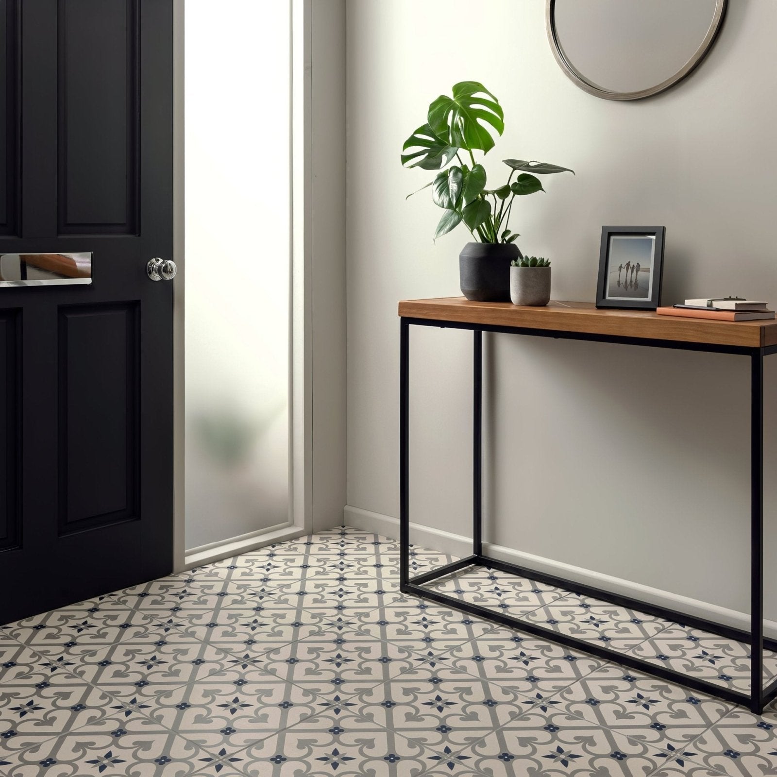 Black and white patterned tile flooring with geometric ornate design in epoque dark blue on chalk finish