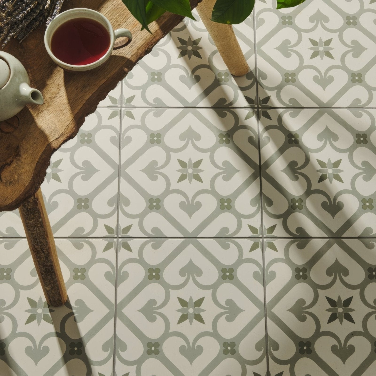 White and sage green patterned ceramic floor tiles with a vintage inspired geometric design epoque green on chalk