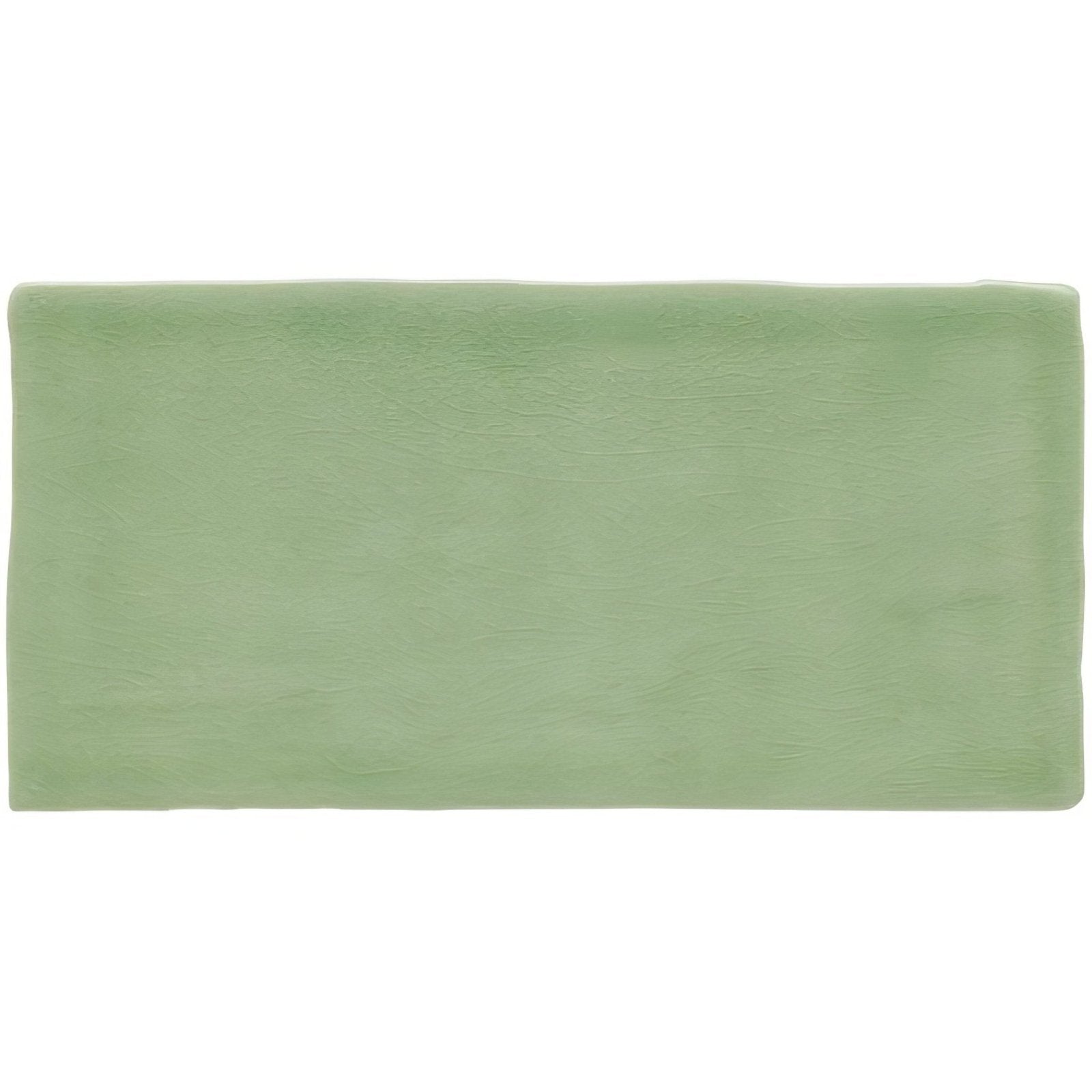A rectangular sage green matte ceramic brick tile called estuary with subtle texture for wall or floor use