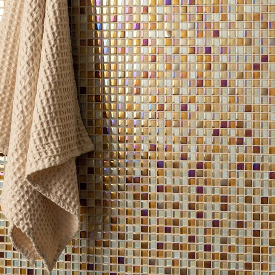 Ethereal Earth and Fire Mixed Mosaics iridescent gold and amber mosaic with a beige waffle towel