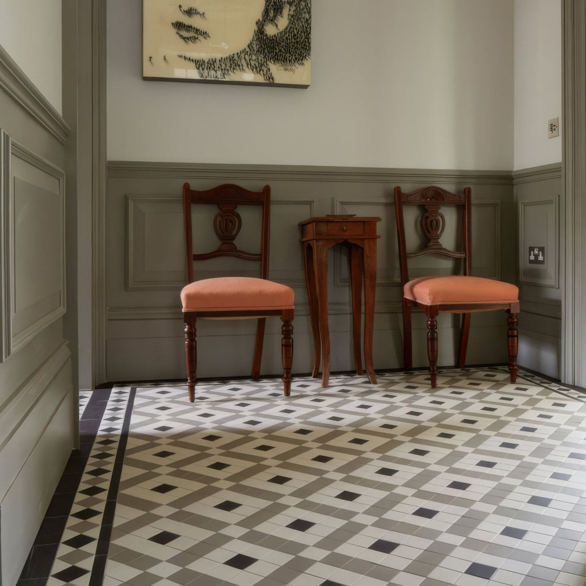 Two matching wooden Exeter black chairs with peach upholstered seats and ornate carved details in Dover white and Holkham dune