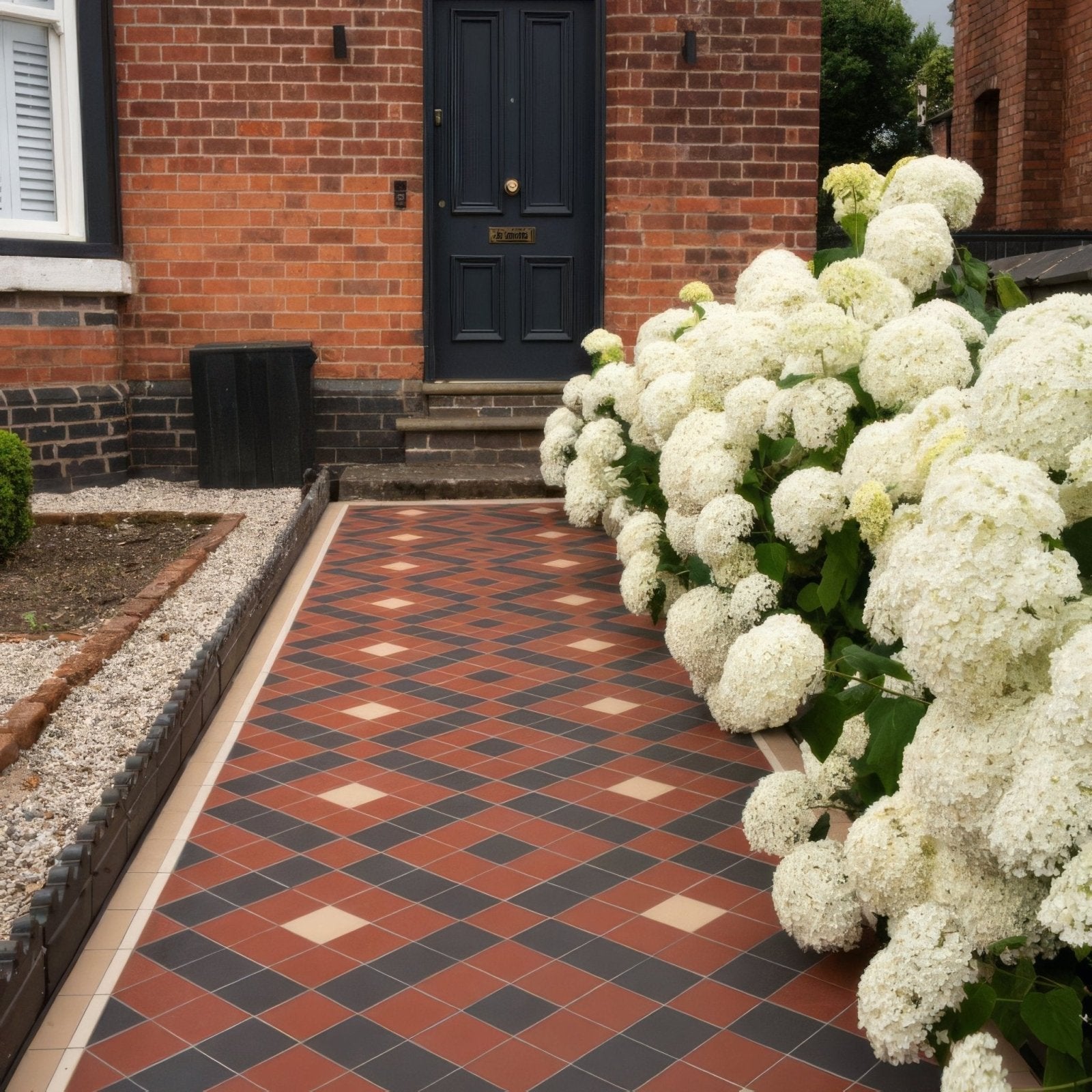 A lush white hydrangea bush with dense rounded flower clusters and dark green leaves for Exeter Black Red and White