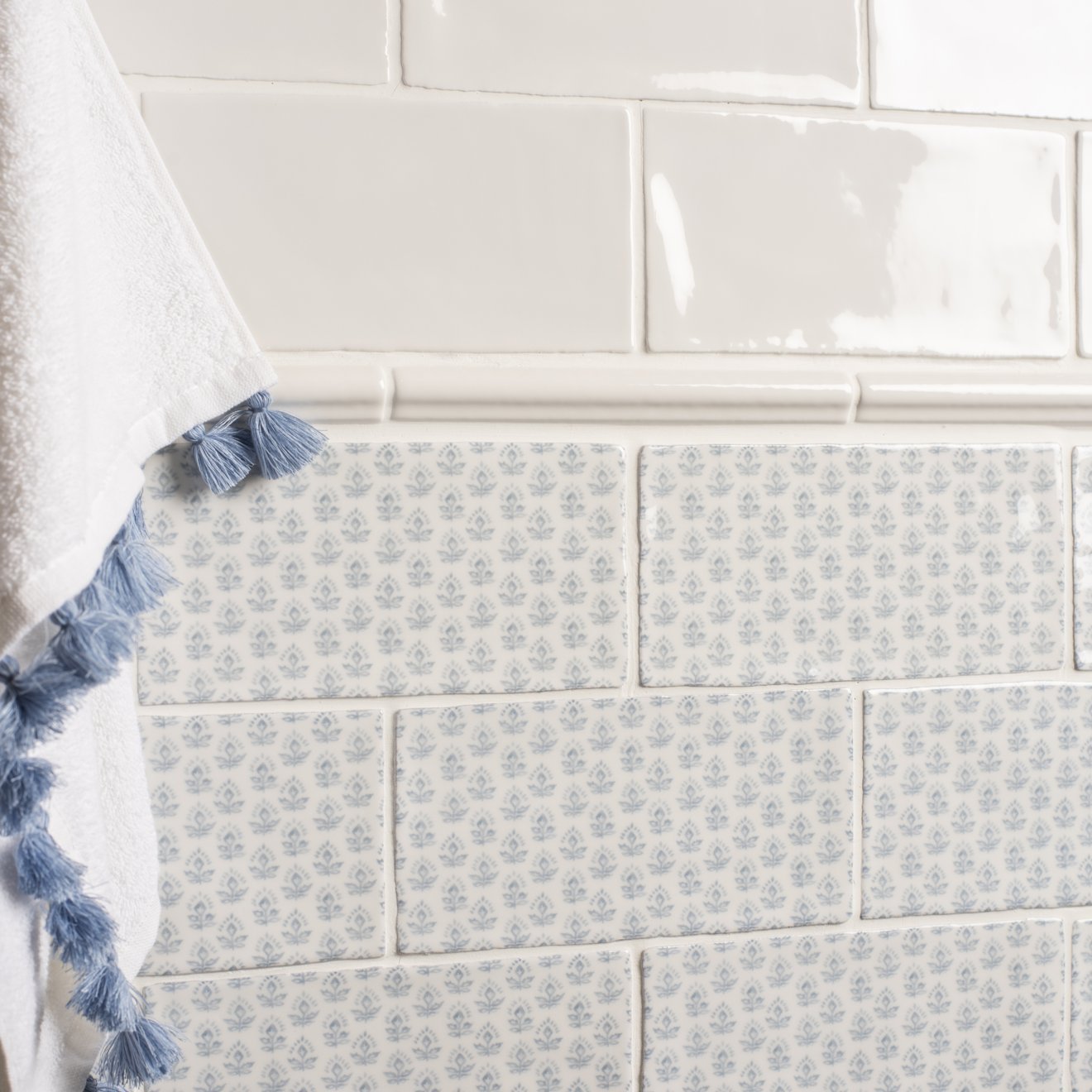 White ceramic subway tiles with subtle gray floral pattern from fabrique picot french blue collection