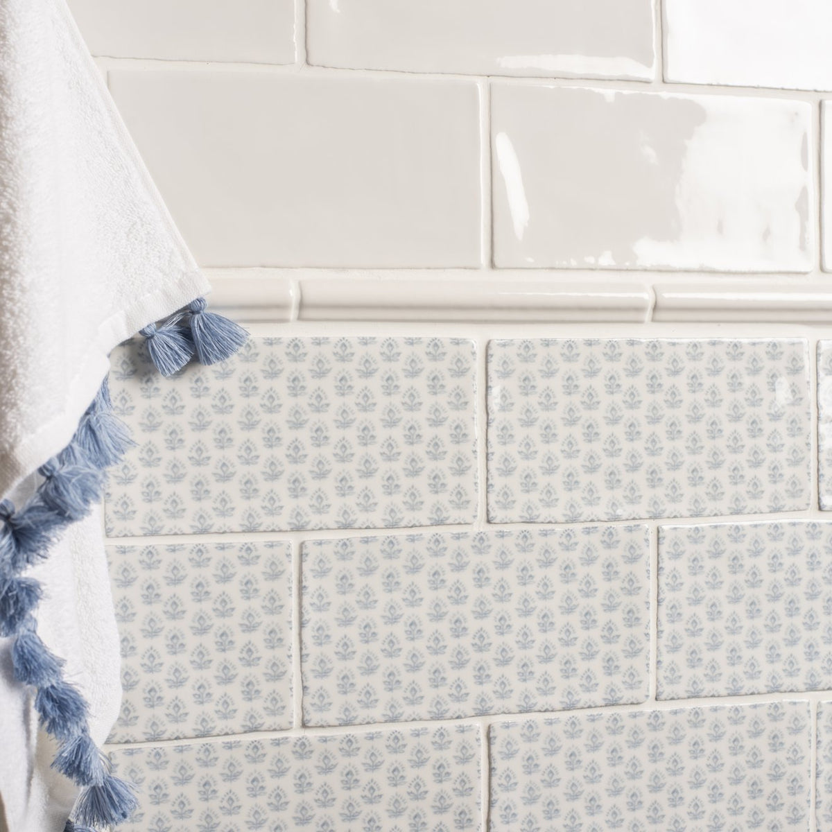 White ceramic subway tiles with subtle gray floral pattern from fabrique picot french blue collection