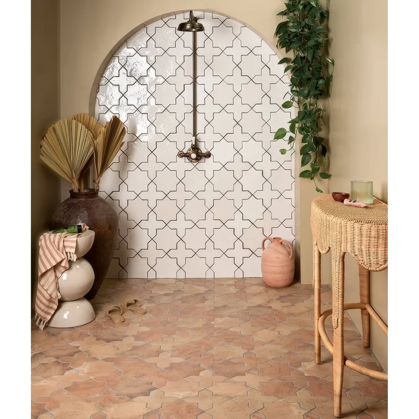 White ceramic fez porcelain star cotto tiles with black geometric patterns adorn an arched shower wall
