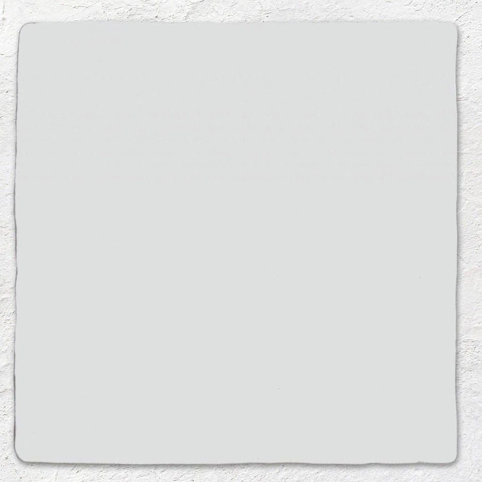 A plain light gray rectangular ceramic field tile with softly rounded corners measuring 13 by 13 centimeters