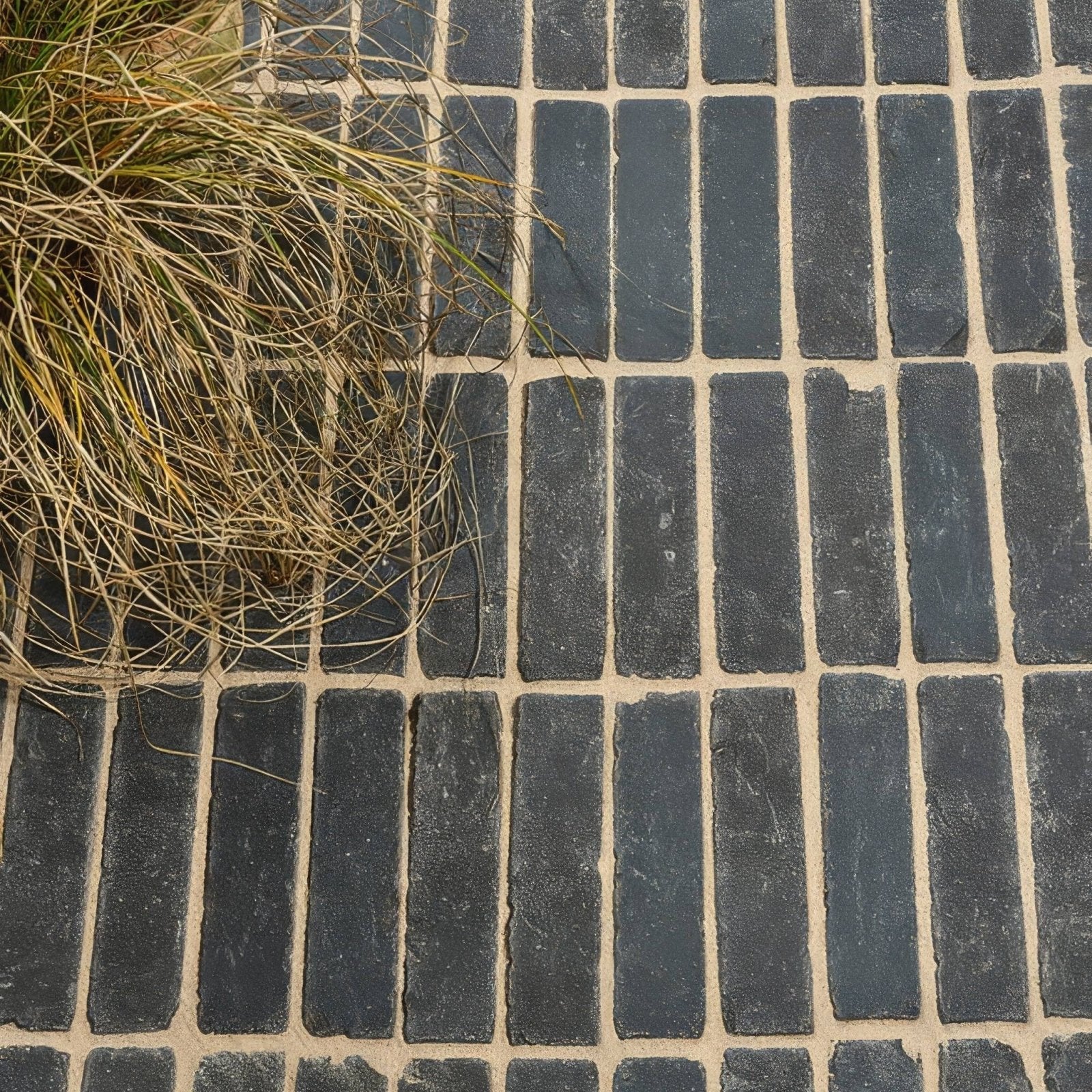 Flanders charcoal tumbled clay pavers in dark gray rectangular bricks with light beige mortar in running bond pattern
