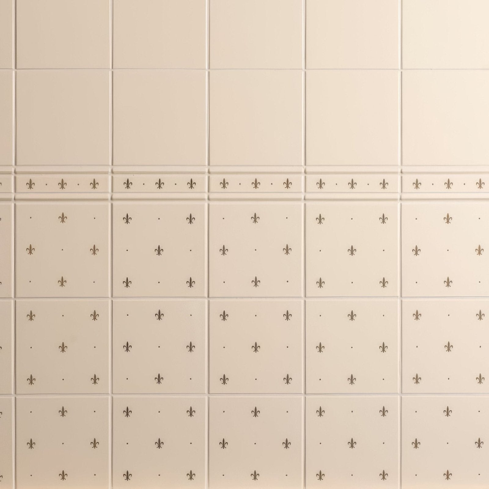 Beige ceramic fleur de lis border gold tiles on county white with subtle black fleur de lis patterns in a grid