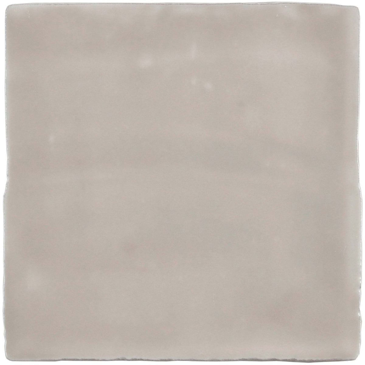 A square matte-finished ceramic tile in soft gray with subtle variations and uneven edges called flint field tile