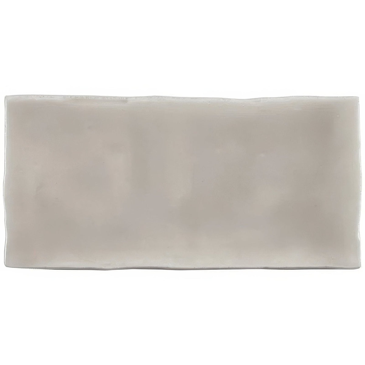 A sleek rectangular flint half tile wall tile with a smooth matte finish in subtle grayish white ceramic