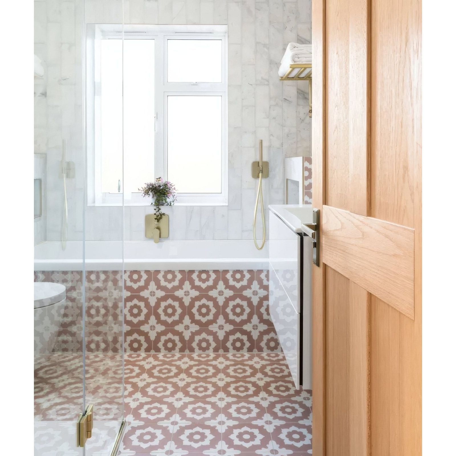 Gold-toned wall-mounted faucet with sleek modern design and curved spout in floris porcelain rose collection