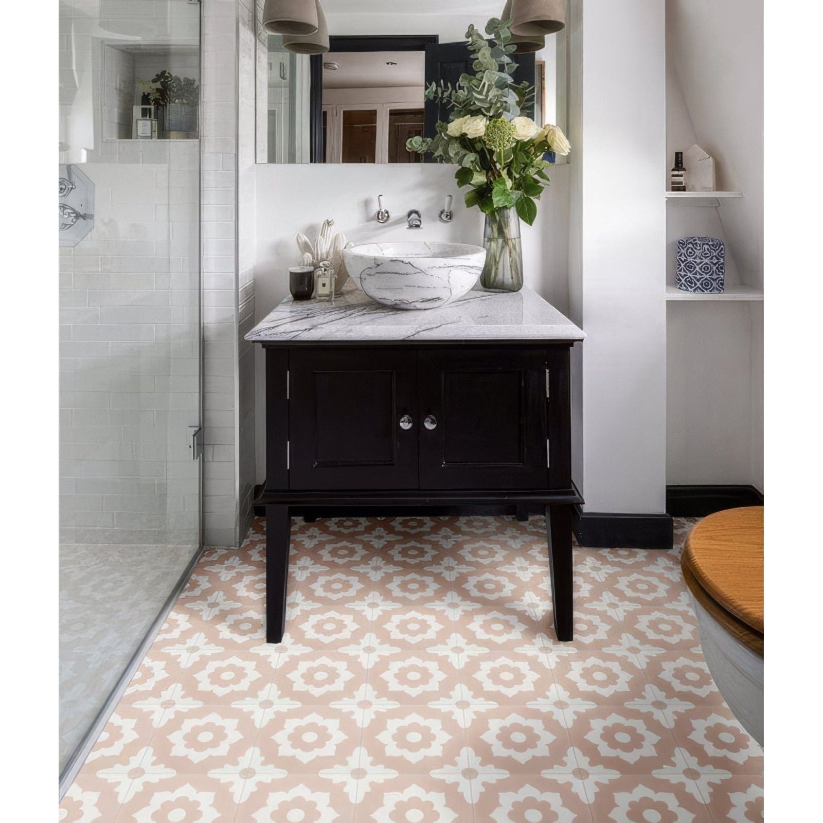 Marble vessel sink with white and gray veins resting on dark wood vanity from floris porcelain rose collection