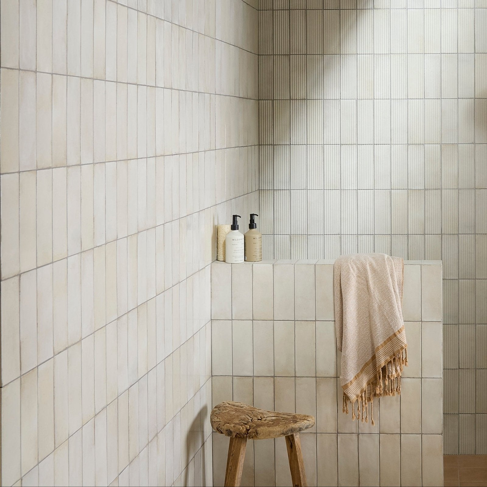 Beige fontenay porcelain metro wall tiles with subtle texture and clean uniform grout lines in vertical subway layout