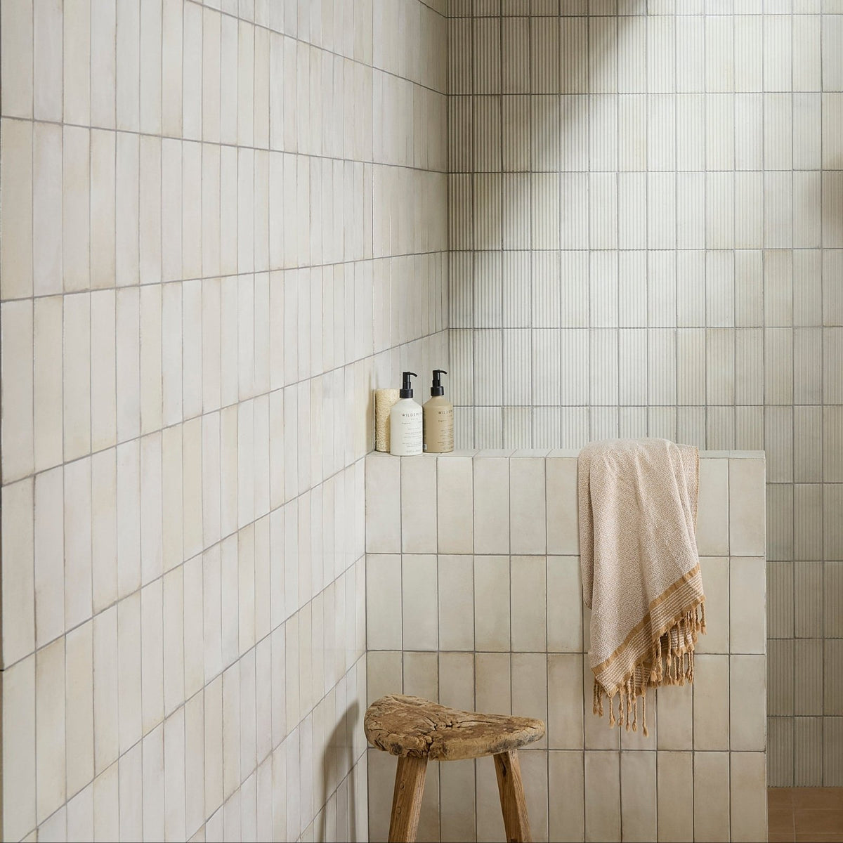 Beige fontenay porcelain metro wall tiles with subtle texture and clean uniform grout lines in vertical subway layout