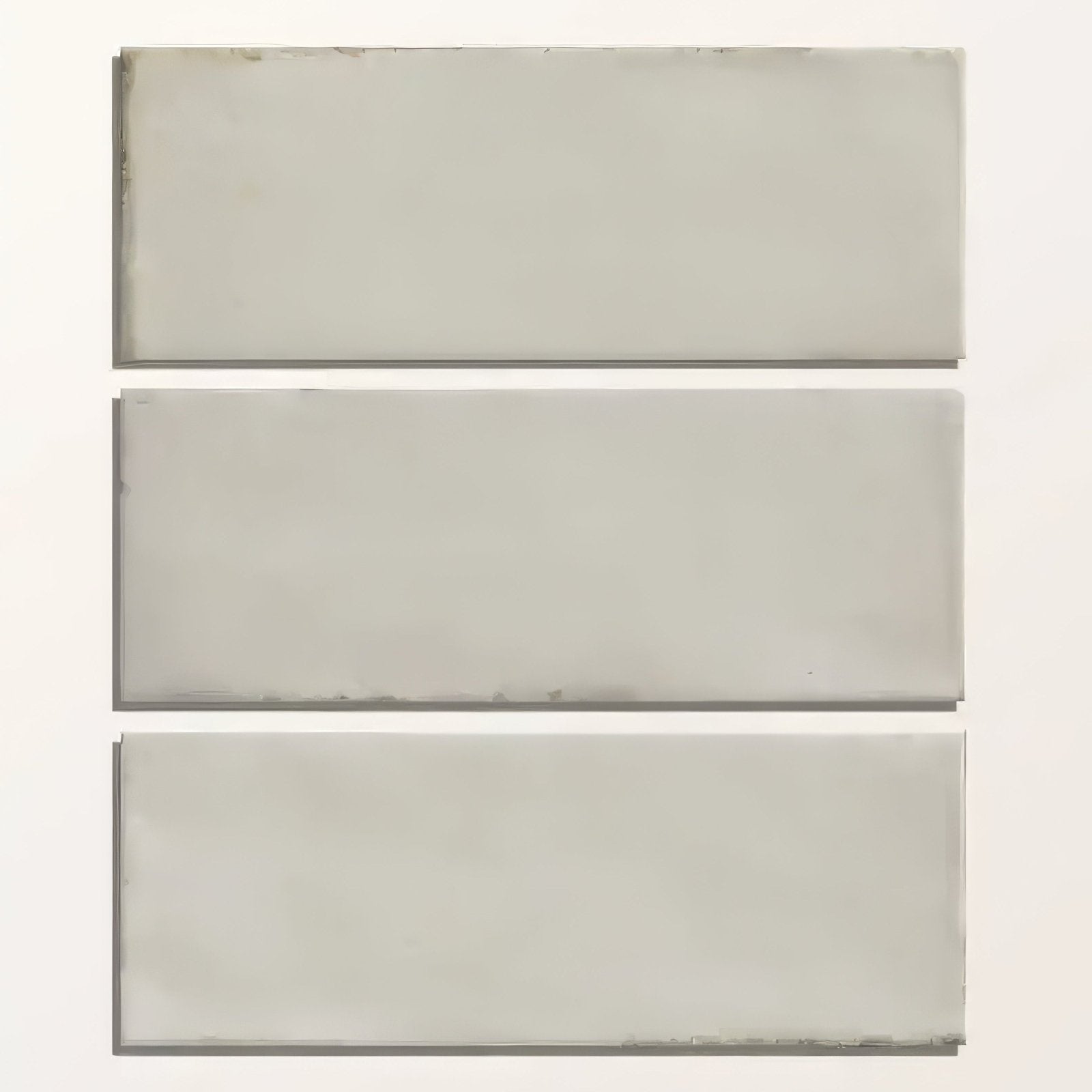 Three gray porcelain subway tiles arranged vertically from the fontenay metro wall tile collection