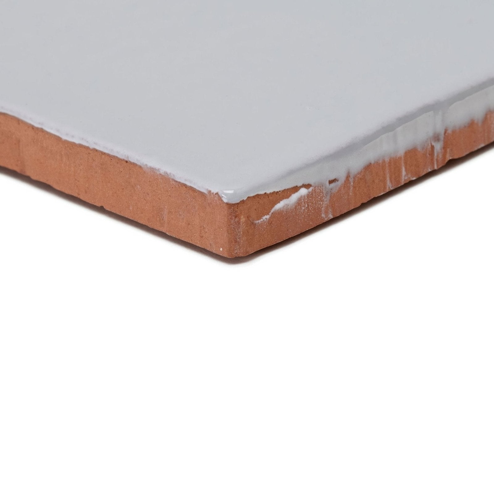 Forecast cromarty square glazed tile showing a smooth light gray ceramic surface with exposed terracotta clay edge