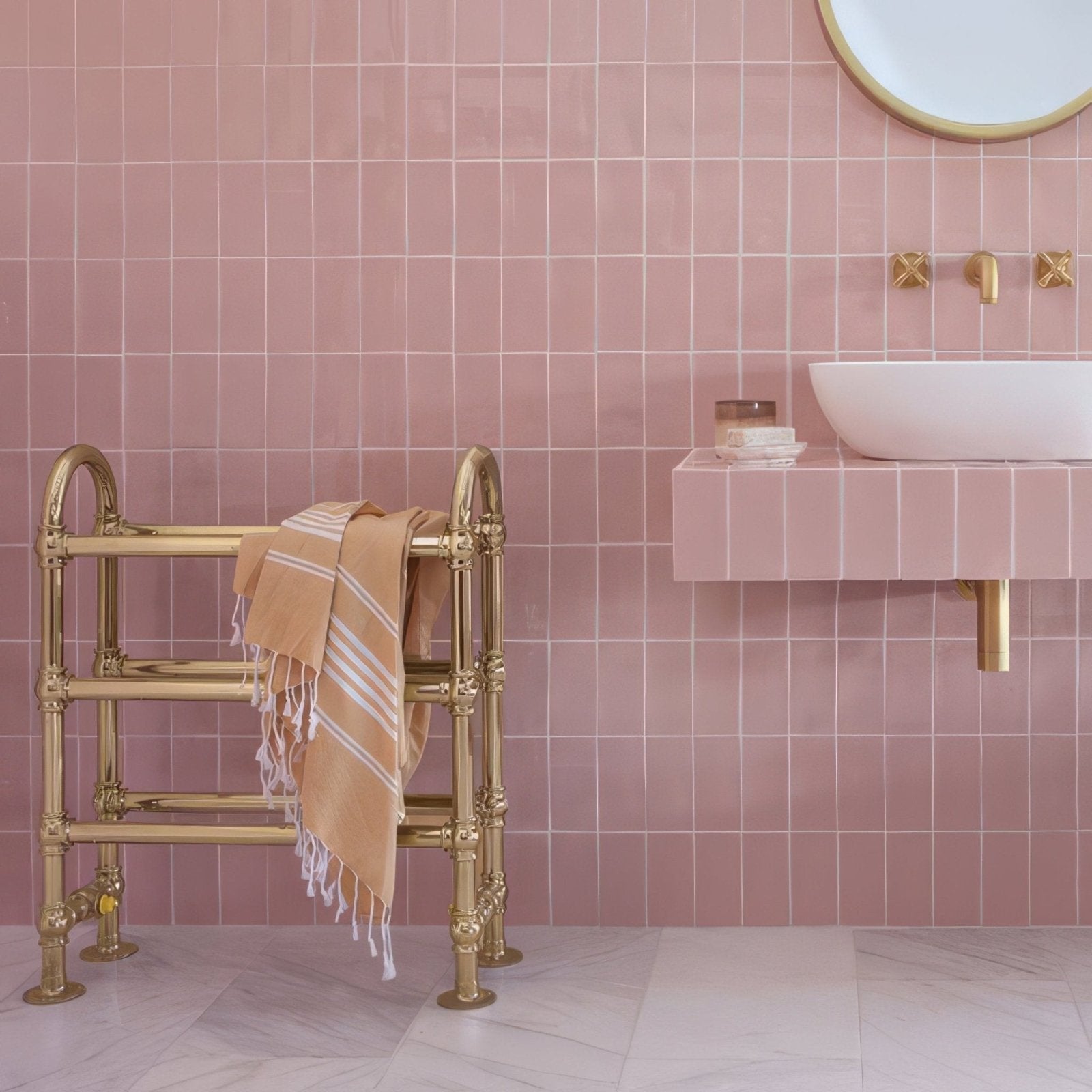 Gold-finished brass towel rack with ornate detailing and beige striped towel for bathroom use